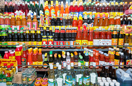 Bangkok, Thailand - June 25, 2011: Close-up of an array of sauces, cooking oil and other ingredients in bottles for sale at the Klong Toey Market