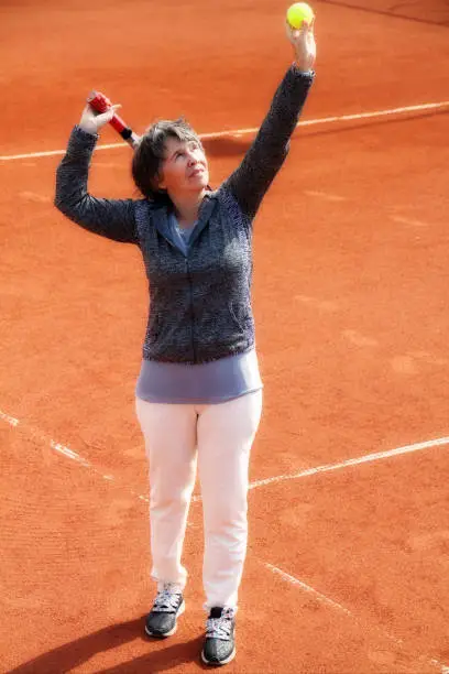 portrait of a senior woman playing tennis