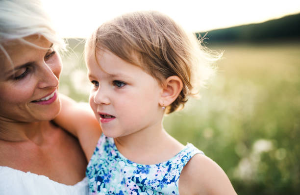 istock Young mother holding a small daughter in nature. 1132298710