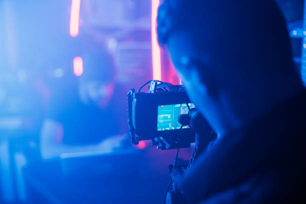 istock The process of filming. Cameraman shoots a scene with a hacker. 1132300567