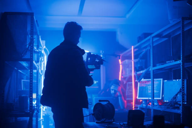 istock The process of filming. Cameraman shoots a scene with a hacker. 1132300582