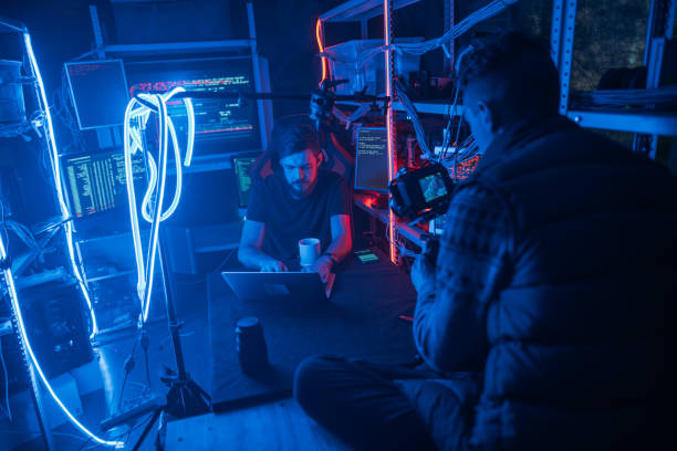 istock The process of filming. Cameraman shoots a scene with a hacker. Backstage 1132300744