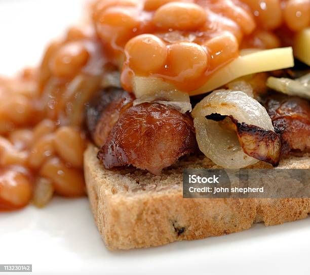 Open Sausage Sandwich With Onions Beans And Cheese Comfort Foo Stock Photo - Download Image Now