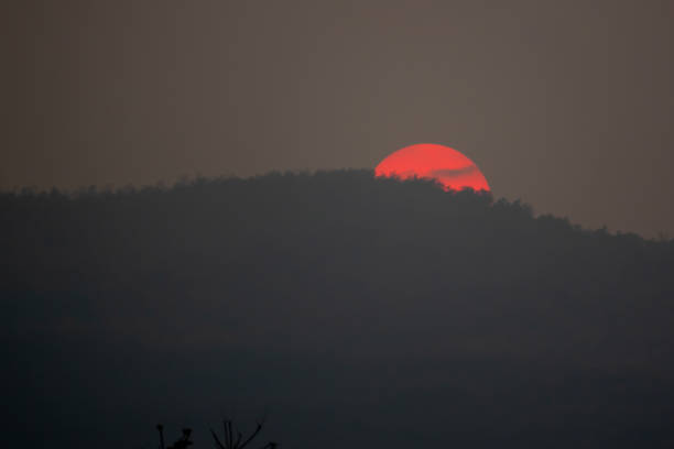 istock Big red sun on hills on sunset view 1132305171