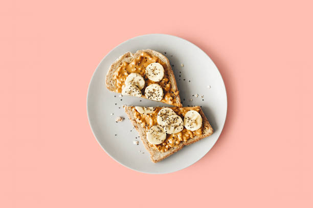 Peanut butter toast Peanut butter chia seed banana toast for breakfast on a pink background, healthy snack, top view chia seed photos stock pictures, royalty-free photos & images