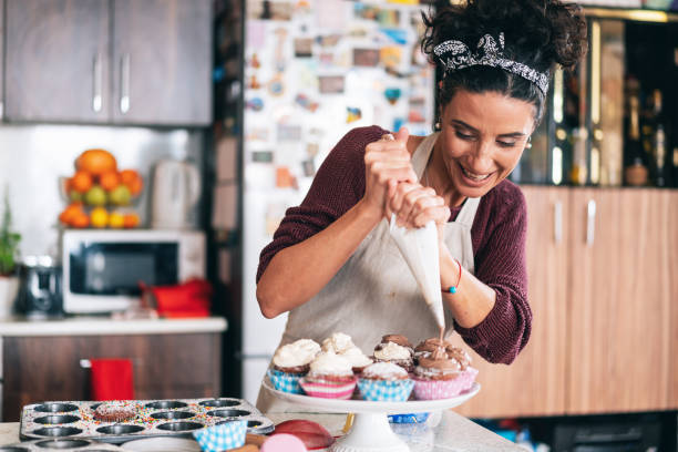 istock Confectioner decorating Chocolate Muffins 1132305755