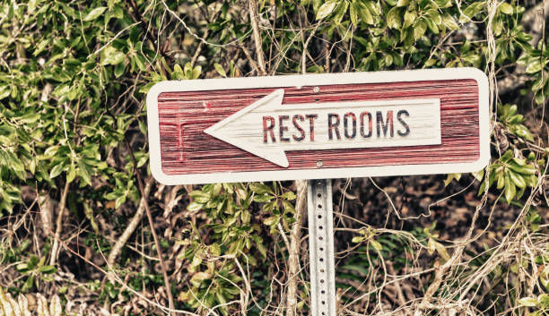 istock Restrooms sign against green background 1132306674