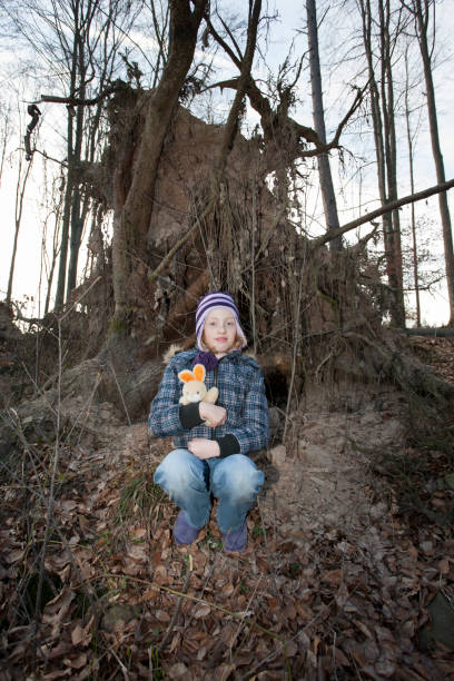 the girl in a forest, with a stuffed animal. the child got lost in the forest. - stuffed animal imagens e fotografias de stock