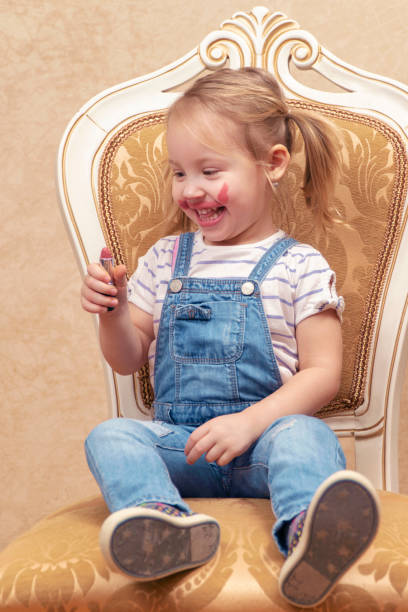 istock child looks at lipstick 1132310038