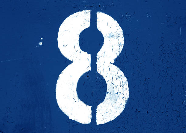 Number eight painted on a peeling blue wall in a rectangle. High quality photo