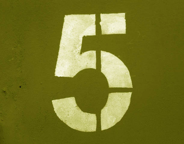 istock Number 5 in stencil on metal wall in yellow tone 1132310885