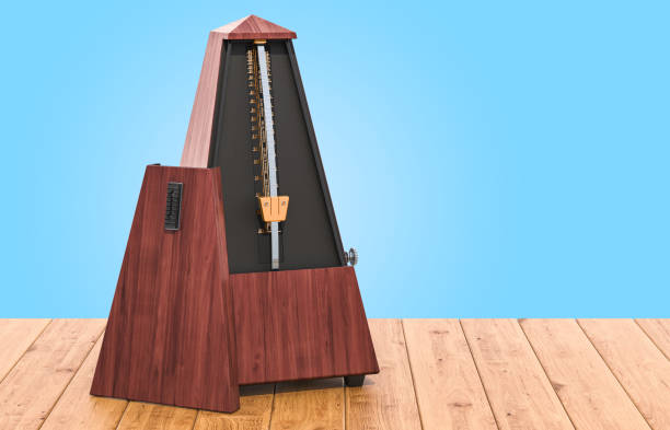 istock Metronome on the wooden table, 3D rendering 1132311291