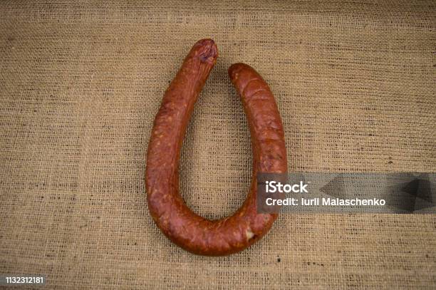 Smoked Sausage Ring On The Background Of Coarse Cloth Stock Photo - Download Image Now