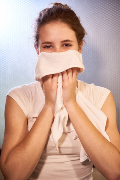 istock Woman wiping her face with towel 1132312419