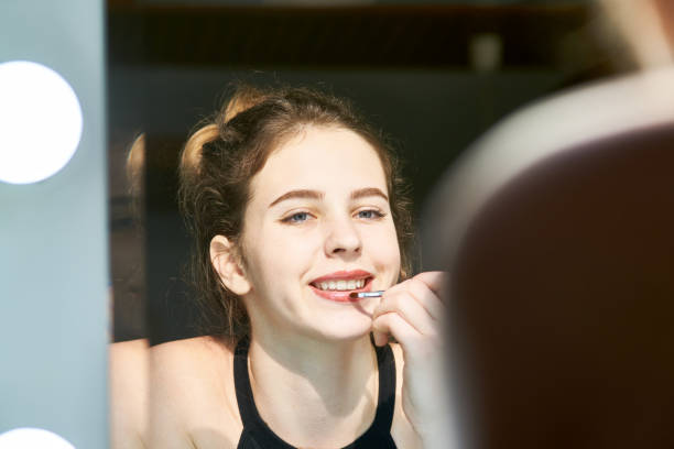 istock Woman applying lipstick 1132312462
