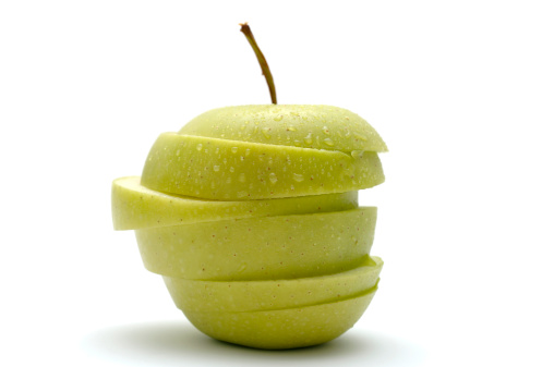 apple green sliced jigsaw covered in water droplets