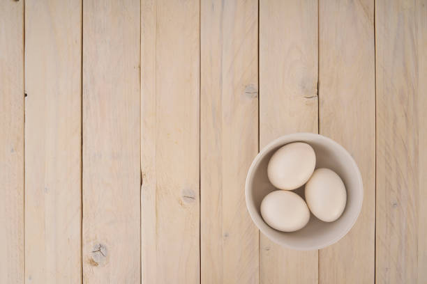 istock Group of chicken eggs in a bowl on wooden background 1132313027