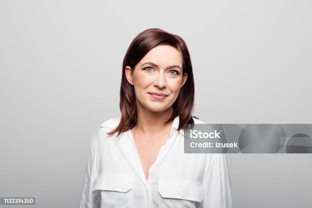 Confident Mature Businesswoman On White Background Stock Photo - Download Image Now - Portrait, Women, One Woman Only