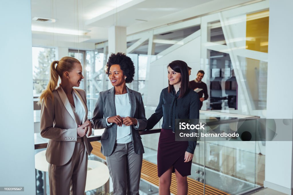 Business is exhausting, time to take a break Business people talking to each other during their office break Businesswoman Stock Photo