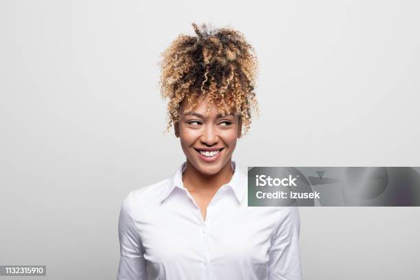 Mid Adult Businesswoman Smiling While Looking Away Stock Photo - Download Image Now - White Background, Sideways Glance, Women