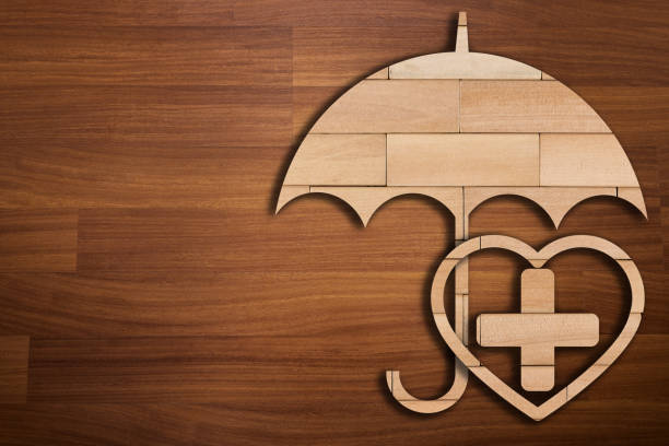 Wooden silhouette of medicine symbol under umbrella - Concept of Insurance Wooden silhouette of medicine symbol under umbrella - Concept of Insurance hospital card stock pictures, royalty-free photos & images