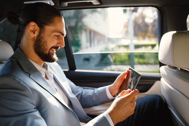 istock Businessman using digital tablet in a taxi 1132315954