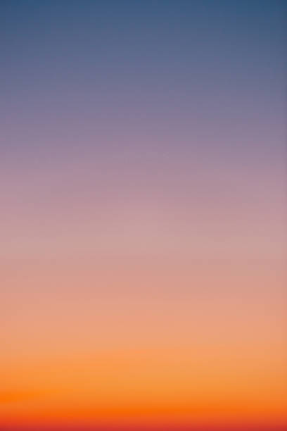 istock Predawn clear sky with orange horizon and violet atmosphere. Smooth orange violet gradient of dawn sky. Background of day beginning. Heaven at early morning with copy space. Sunset, sunrise backdrop 1132317184