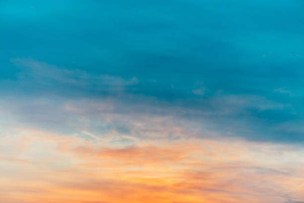 istock Sunset sky with orange yellow light clouds. Colorful smooth blue sky gradient. Natural background of sunrise. Amazing heaven at morning. Slightly cloudy evening atmosphere. Wonderful weather on dawn. 1132317197
