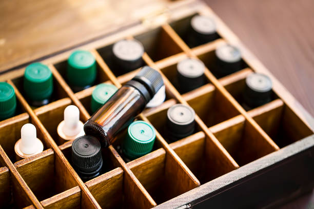 Aromatherapy essential oils in wooden box. Herbal alternative medicine with essential oils bottles in wooden box, healthy organic natural therapy