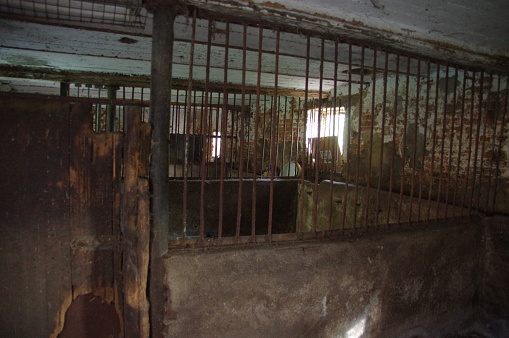 A shot of a prison cell with a lattice door