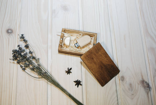 istock Decorative wooden box for presents, memory sticks or money. Ecological friendly package for wrapping. Lavender, anise-tree stars and cinnamon lying nearby. Rustic vintage style. 1132319420