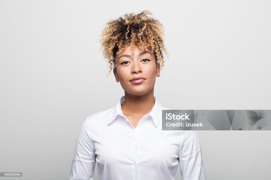 Portrait of confident mid adult businesswoman Portrait of confident mid adult businesswoman. Close-up of attractive executive is against white background. She is having curly blond hair. Women Stock Photo