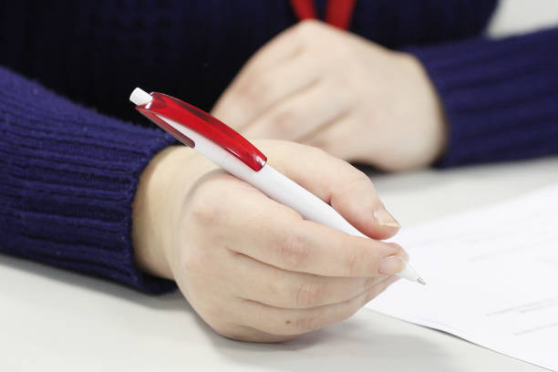 istock woman's hand holding pen 1132321663