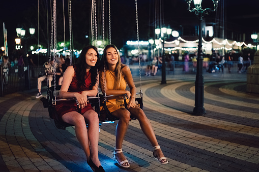 Girls on swing ride at night