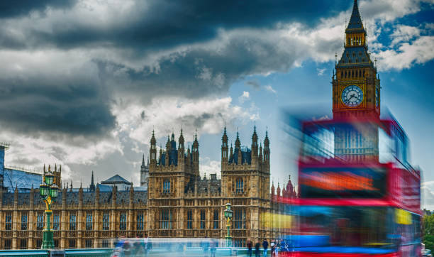 istock Red bus speeding up along Westminster Bridge, blurred view with long exposure 1132323040