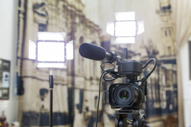 istock Shooting a report in the interior. Video equipment: camera, on-camera microphone gun, led lighting device, tripod 1132323374
