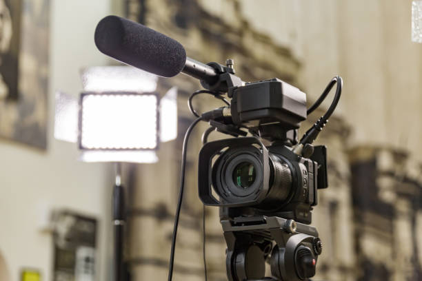 istock Shooting a report in the interior. Video equipment: camera, on-camera microphone gun, led lighting device, tripod 1132323376