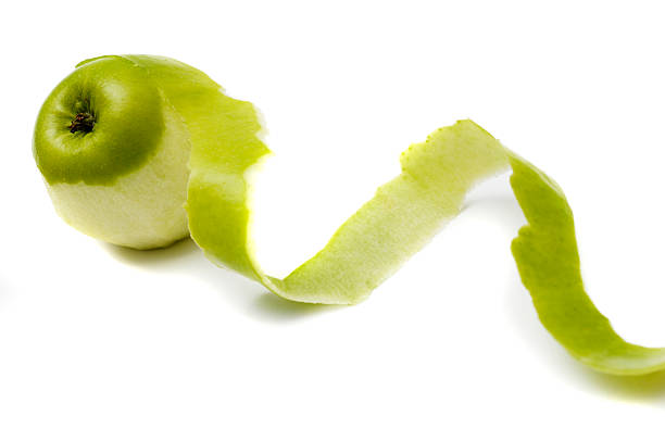 istock Apple peeled with twisting skin against white 113232342