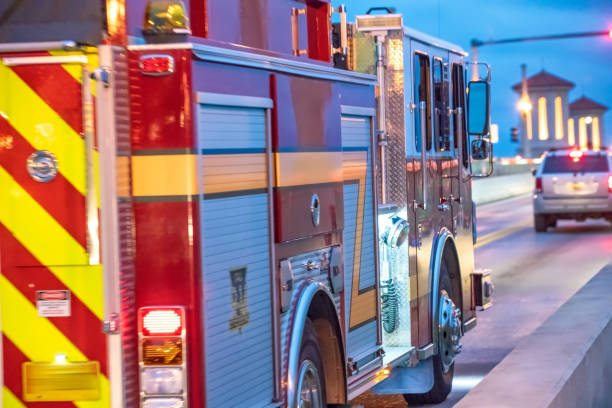 istock Firefighter truck at night speeding up 1132323559