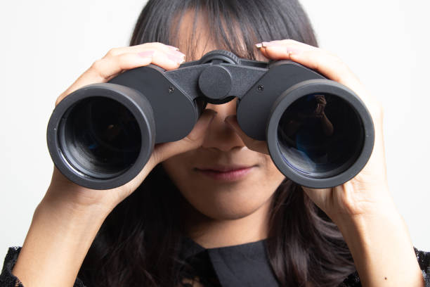 istock Young Asian woman with binoculars. 1132323562