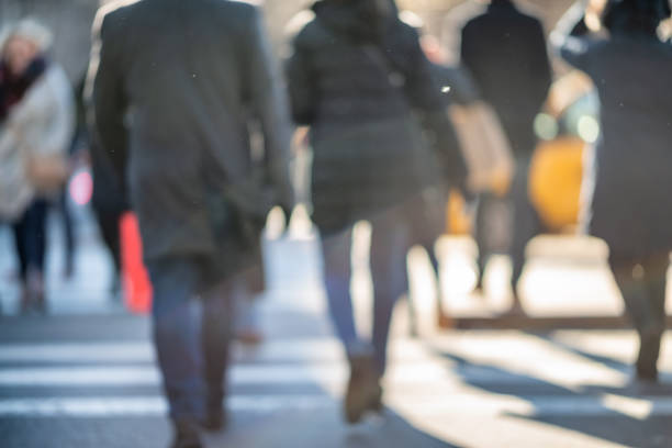 istock Blurred back view of people walking in the city 1132323664
