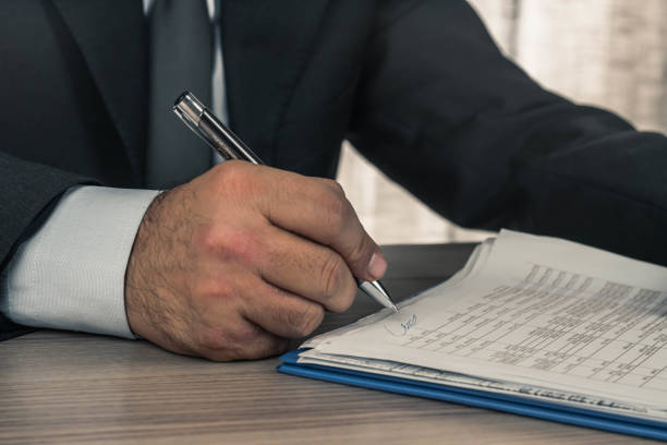 istock man working in office signing agreement 1132323689