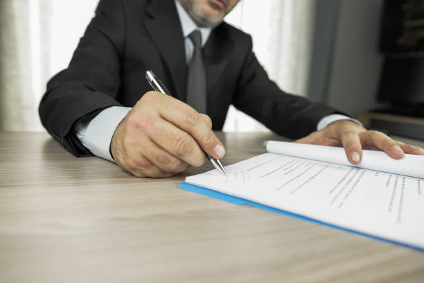 istock man working in office signing agreement 1132323709