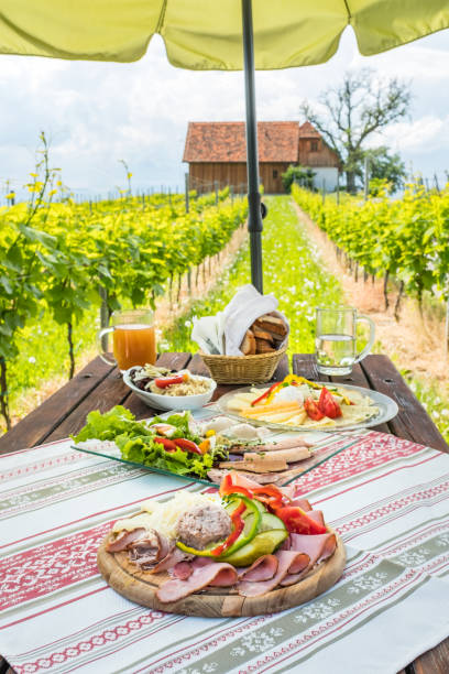 istock Brettljause, cold plate with meal on wooden table in vineyard 1132323742