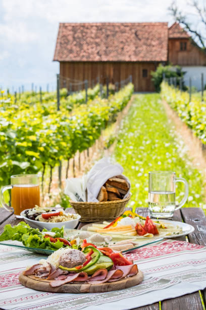 istock Brettljause, cold plate with meal on wooden table in vineyard 1132323743
