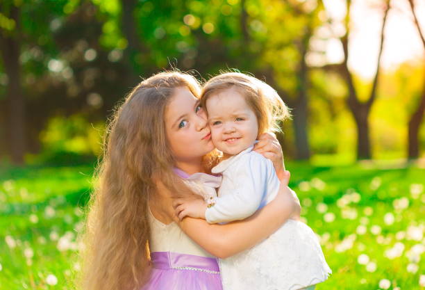 istock girl, sisters, embrace, fun 1132324100