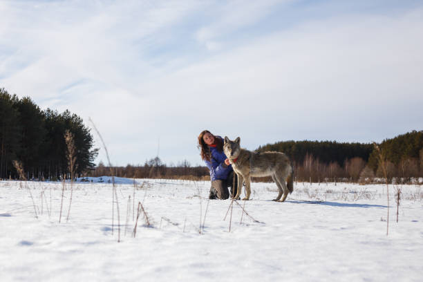 istock Woman and Her Wolf in the Snow 1132325193