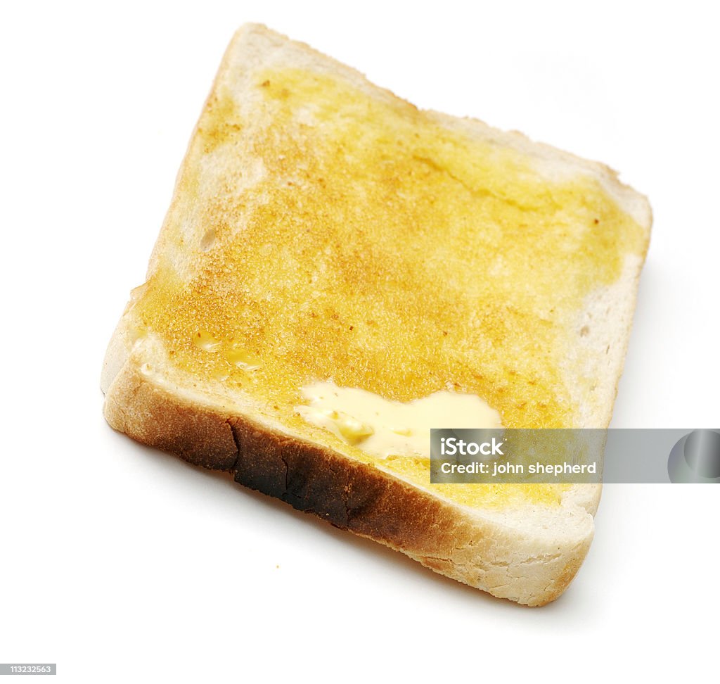 Fetta di pane tostato bianco distesa - Foto stock royalty-free di Burro