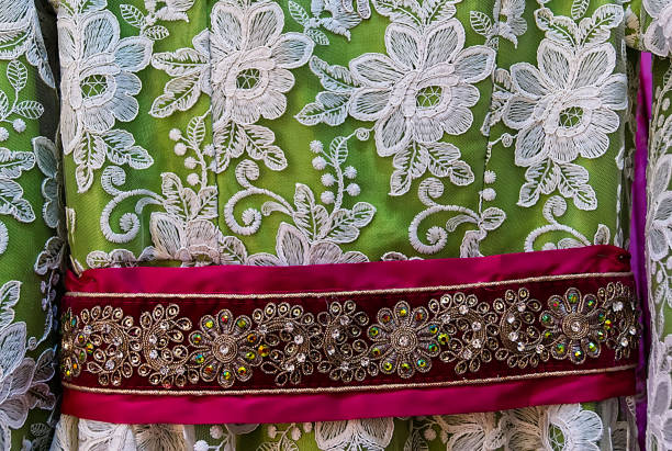 istock White and red floral design on textile green background 1132325785