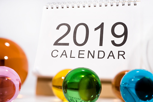 Abstract photo with 2019 calendar and glass balls.